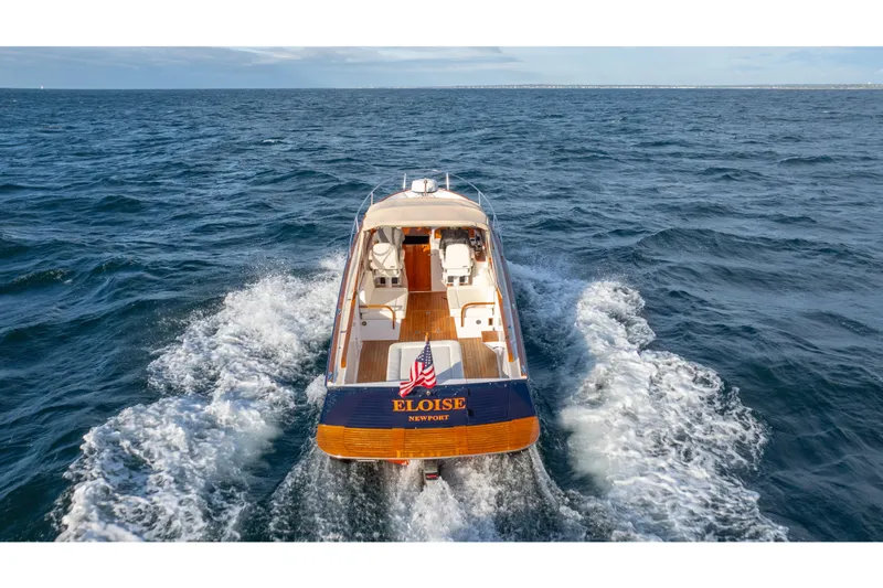 Slide: The Image of 2020 CH Marine Shelter Island Nomad cruising on open sea, rear view with American flag. - 20
