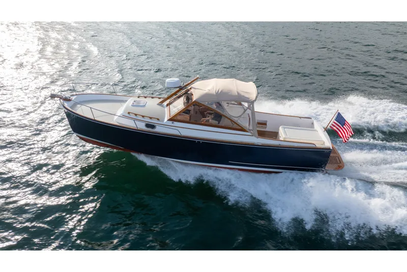 Slide: The Image of 2020 CH Marine Shelter Island Nomad cruising on open water with American flag. - 23