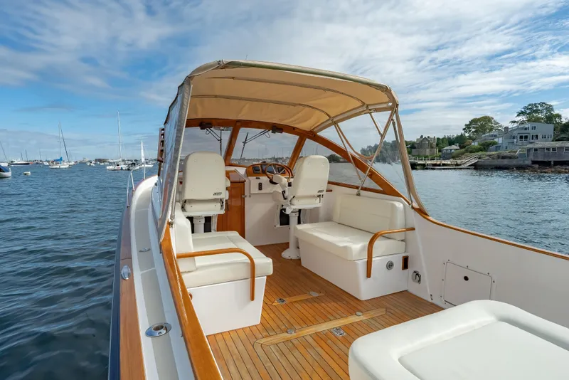 Slide: The Image of 2020 CH Marine Shelter Island Nomad boat with elegant interior, docked in a scenic harbor. - 9