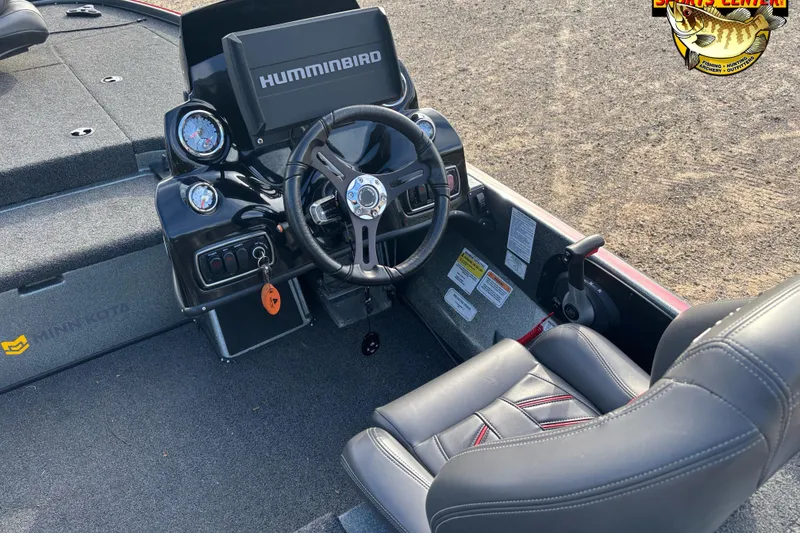 Slide: The Image of 2017 Nitro Z18 boat cockpit with steering wheel, Humminbird display, and comfortable seating. - 10