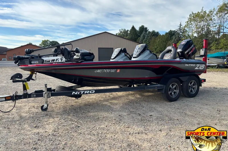 Slide: The Image of 2017 Nitro Z18 boat on trailer at D&R Sports Center, parked outdoors. - 5