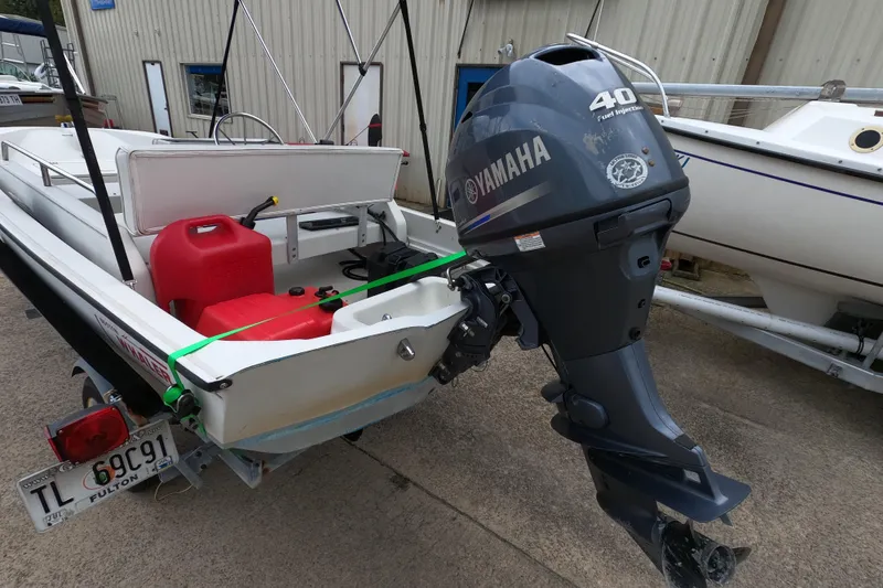 Slide: The Image of 1992 Boston Whaler 13 GLS boat with Yamaha 40 outboard motor, parked on trailer. - 3