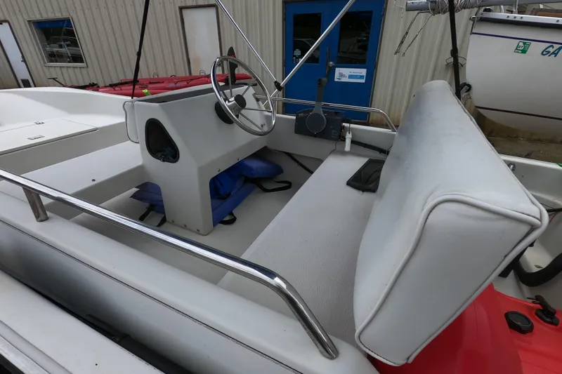 Slide: The Image of 1992 Boston Whaler 13 GLS boat interior with steering wheel and seating. - 4