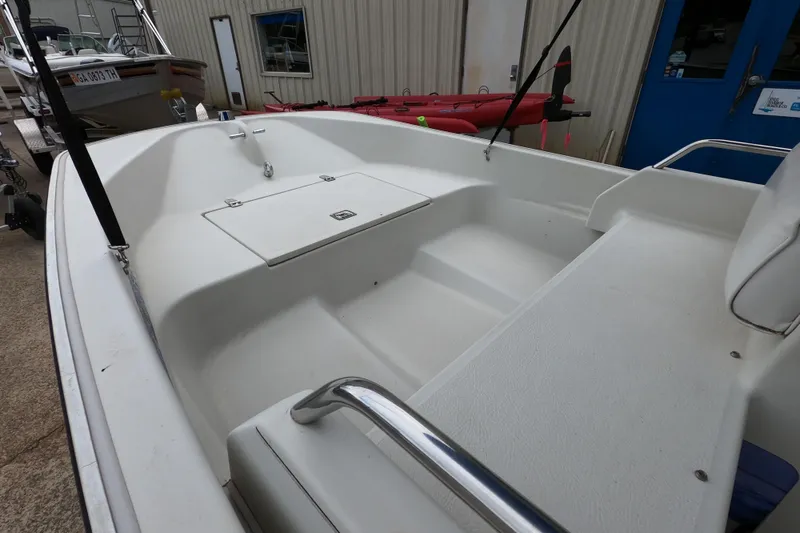 Slide: The Image of 1992 Boston Whaler 13 GLS boat interior, featuring seating and storage compartments. - 6