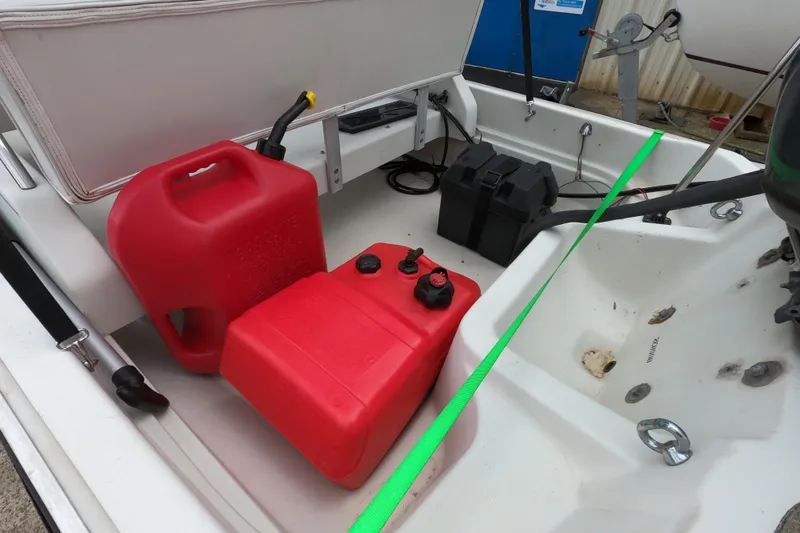 Slide: The Image of 1992 Boston Whaler 13 GLS boat interior with red fuel containers and battery box. - 8