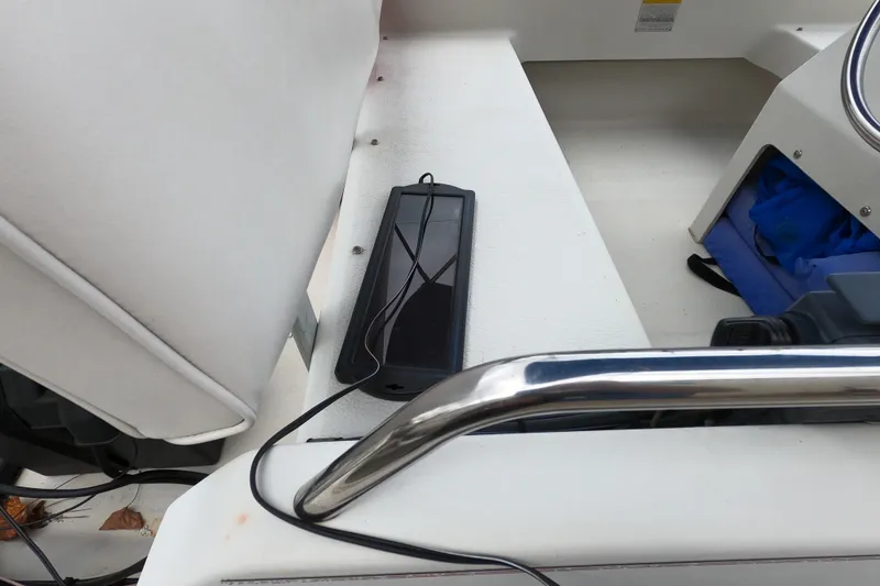 Slide: The Image of Interior of a 1992 Boston Whaler 13 GLS boat with a solar panel and blue storage bag. - 9