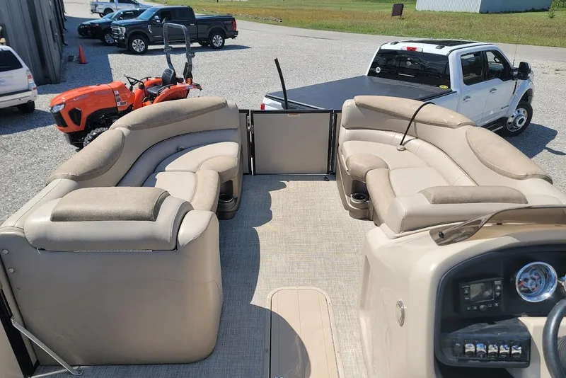 Slide: The Image of 2020 Avalon Catalina Elite 23' pontoon boat interior with plush seating and dashboard. - 13