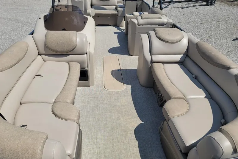 Slide: The Image of 2020 Avalon Catalina Elite 23' pontoon boat interior with beige seating and spacious layout. - 18
