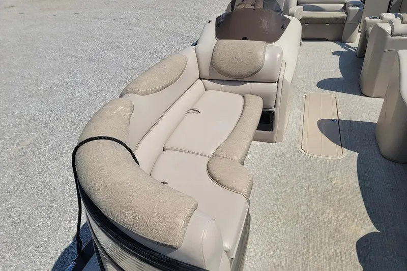 Slide: The Image of 2020 Avalon Catalina Elite 23' boat interior with beige seating and carpeted floor. - 19
