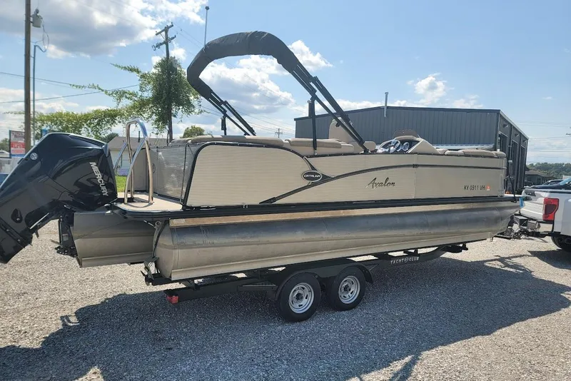 The Image of 2020 Avalon Catalina Elite 23' pontoon boat on trailer, parked outdoors. - 3