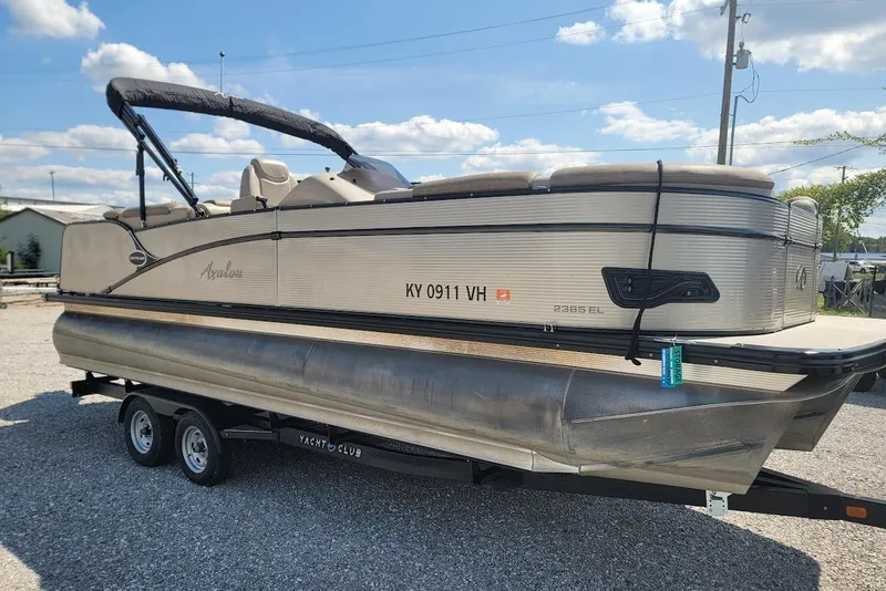 Slide: The Image of 2020 Avalon Catalina Elite 23' pontoon boat on trailer under blue sky. - 5