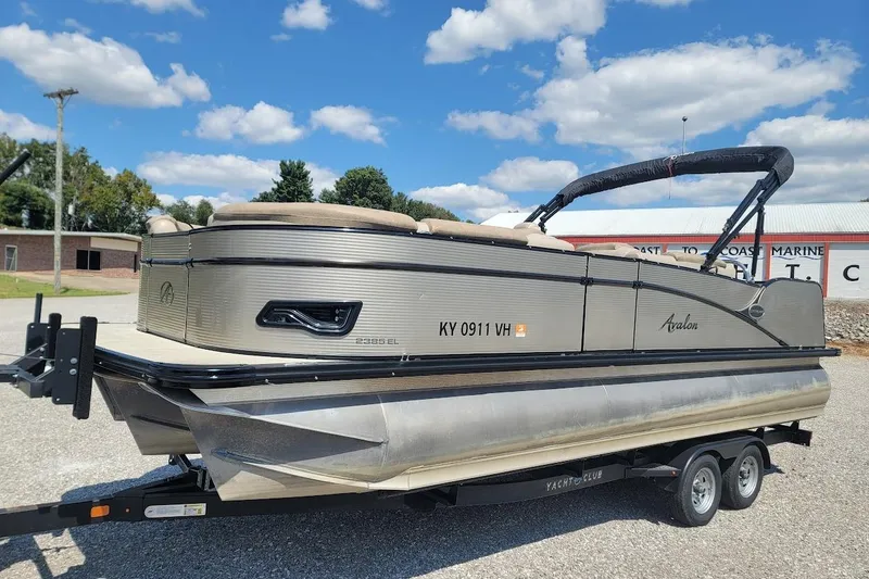 Slide: The Image of 2020 Avalon Catalina Elite 23' pontoon boat on trailer under a blue sky. - 7