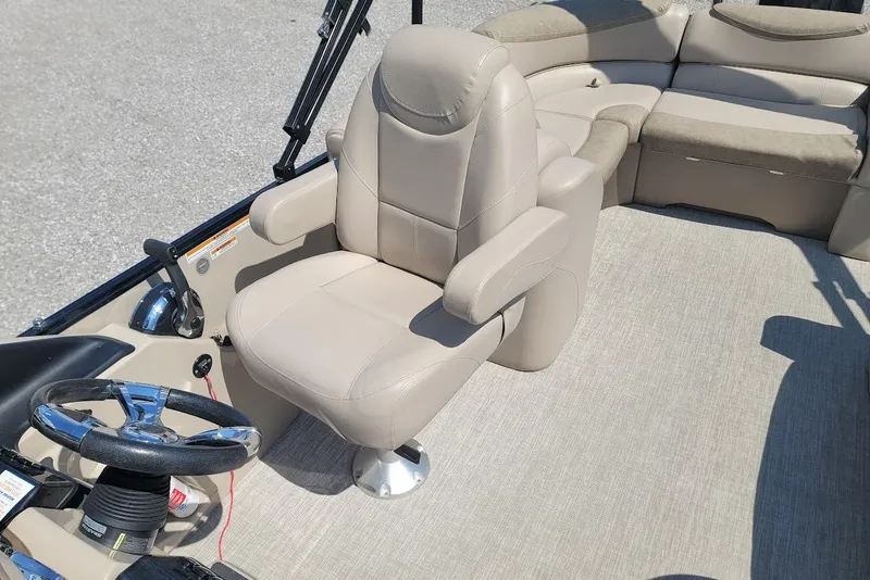 Slide: The Image of 2020 Avalon Catalina Elite 23' boat interior with beige seating and steering wheel. - 8