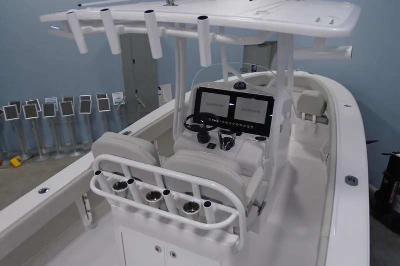 Slide: The Image of 2026 Jupiter 26 boat interior with dual Garmin displays and rod holders. - 11