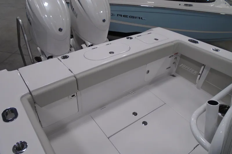 Slide: The Image of 2026 Jupiter 26 boat deck with dual engines and storage compartments. - 12