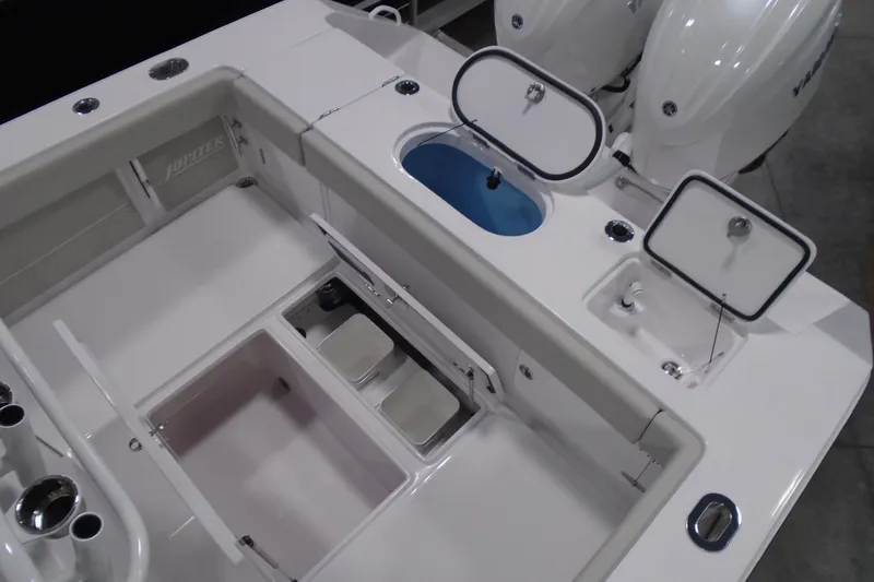 Slide: The Image of 2026 Jupiter 26 boat deck with storage compartments and dual engines. - 13