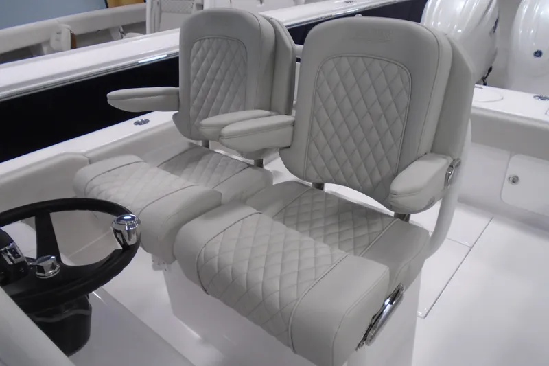 Slide: The Image of Luxurious seating on 2026 Jupiter 26 boat with quilted upholstery and armrests. - 15