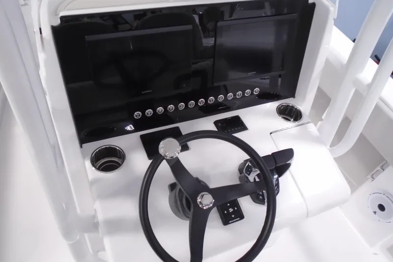 Slide: The Image of Steering console of 2026 Jupiter 26 boat with dual screens and modern controls. - 17
