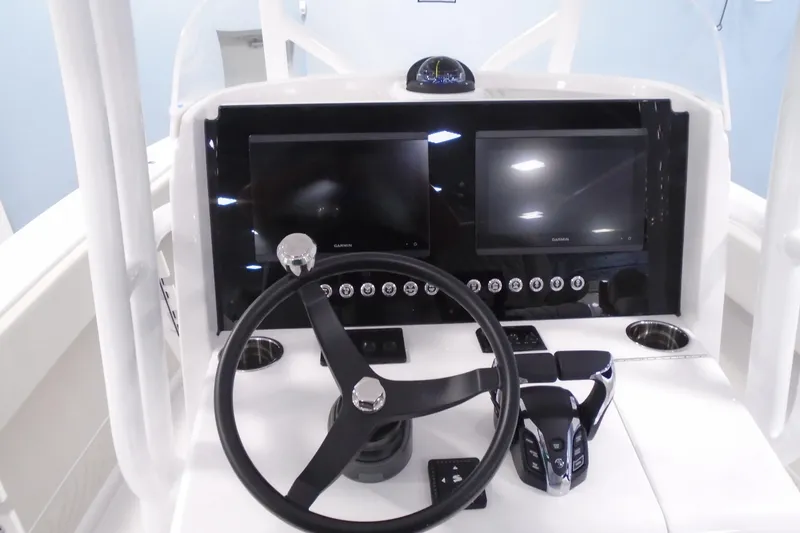 Slide: The Image of Helm of 2026 Jupiter 26 boat with dual Garmin displays and modern controls. - 18