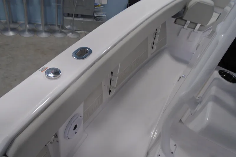 Slide: The Image of Interior view of a 2026 Jupiter 26 boat, showcasing sleek white seating and fixtures. - 21