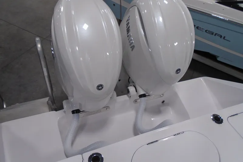 Slide: The Image of Twin Yamaha outboard engines on a 2026 Jupiter 26 boat, displayed indoors. - 32