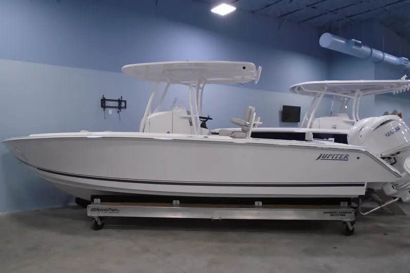 The Image of 2026 Jupiter 26 boat in showroom, side view, white hull, modern design. - 6