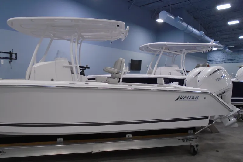Slide: The Image of 2026 Jupiter 26 boat in showroom, featuring sleek design and powerful engines. - 7