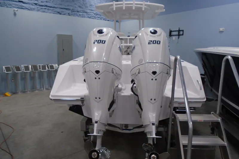 Slide: The Image of Twin 200 horsepower outboard engines on a 2026 Jupiter 26 boat in a showroom. - 9