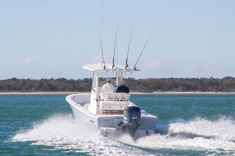 Slide: The Image of 2026 Regulator 24XO boat with Yamaha engine at dealership, rear view. - 3