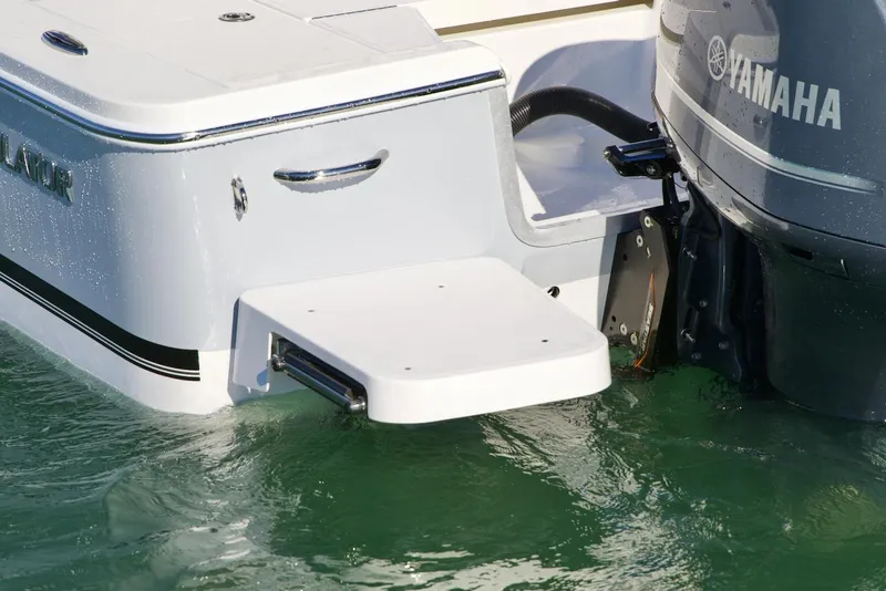 Slide: The Image of 2026 Regulator 24XO boat with Garmin equipment, parked outdoors near industrial building. - 5