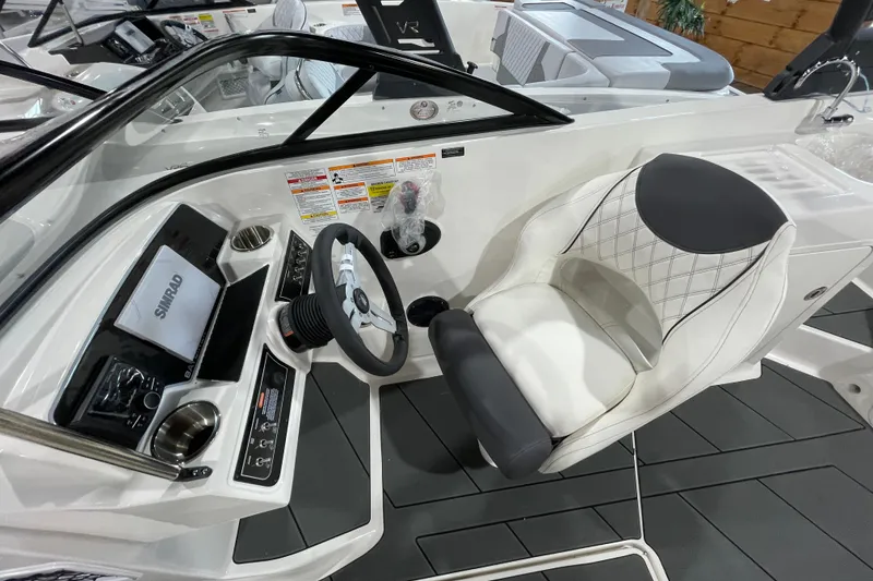 Slide: The Image of 2026 Bayliner D22I boat cockpit with steering wheel and modern dashboard controls. - 11