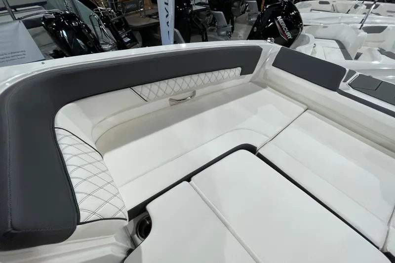 Slide: The Image of Interior seating of 2026 Bayliner D22I boat, featuring white and black upholstery. - 14