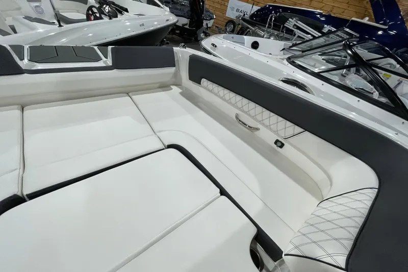 Slide: The Image of 2026 Bayliner D22I boat interior with white cushioned seating and sleek design. - 15
