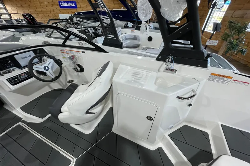 Slide: The Image of 2026 Bayliner D22I boat interior with steering wheel and seating area. - 9