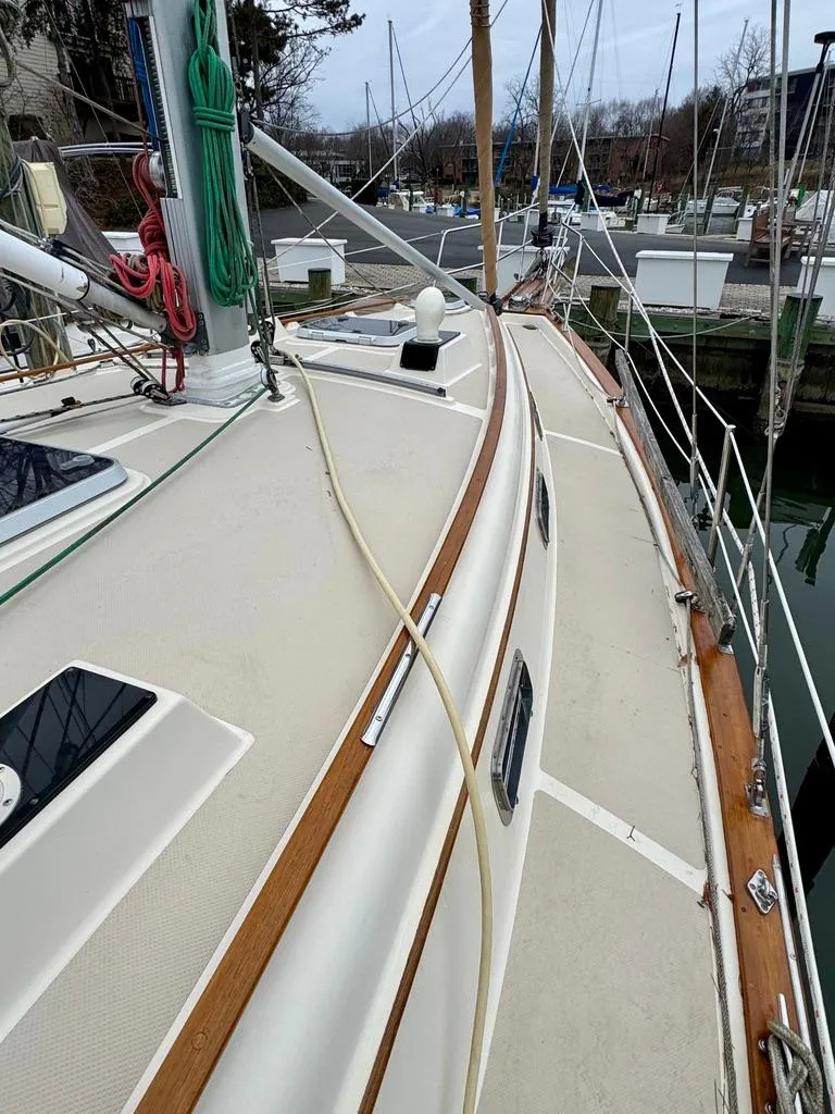 Slide: The Image of 2000 Island Packet 40 sailboat deck with ropes and fittings in a marina. - 1