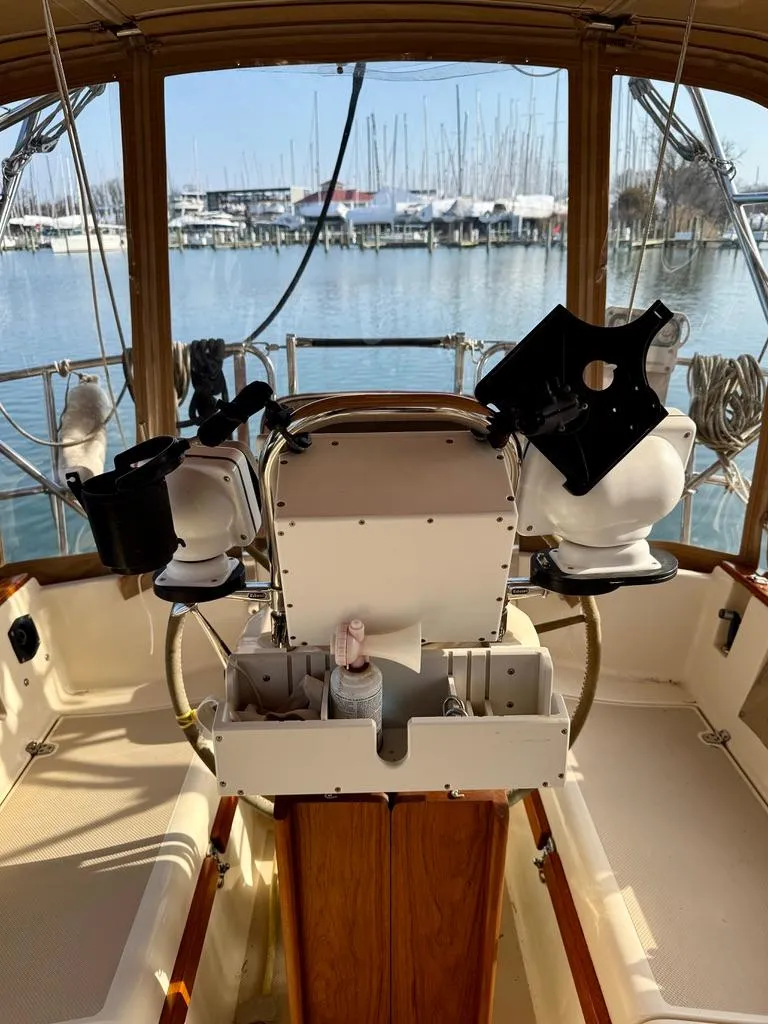 Slide: The Image of Cockpit view of a 2000 Island Packet 40 sailboat docked at a marina. - 12