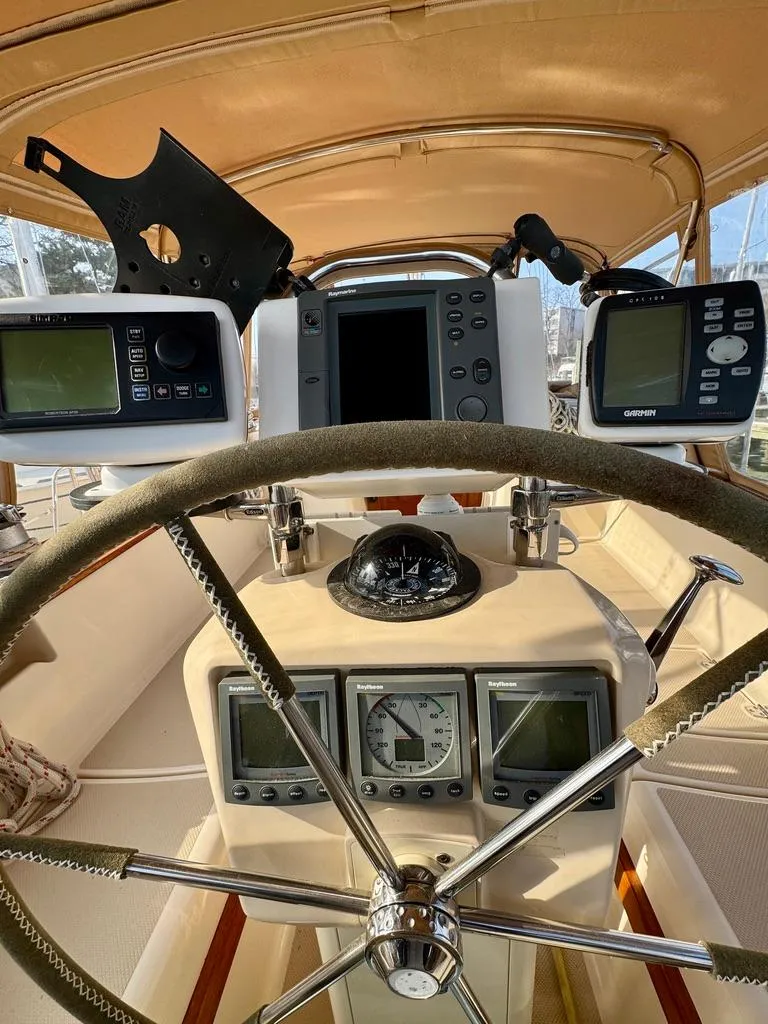Slide: The Image of Cockpit of 2000 Island Packet 40 sailboat with navigation instruments and steering wheel. - 13