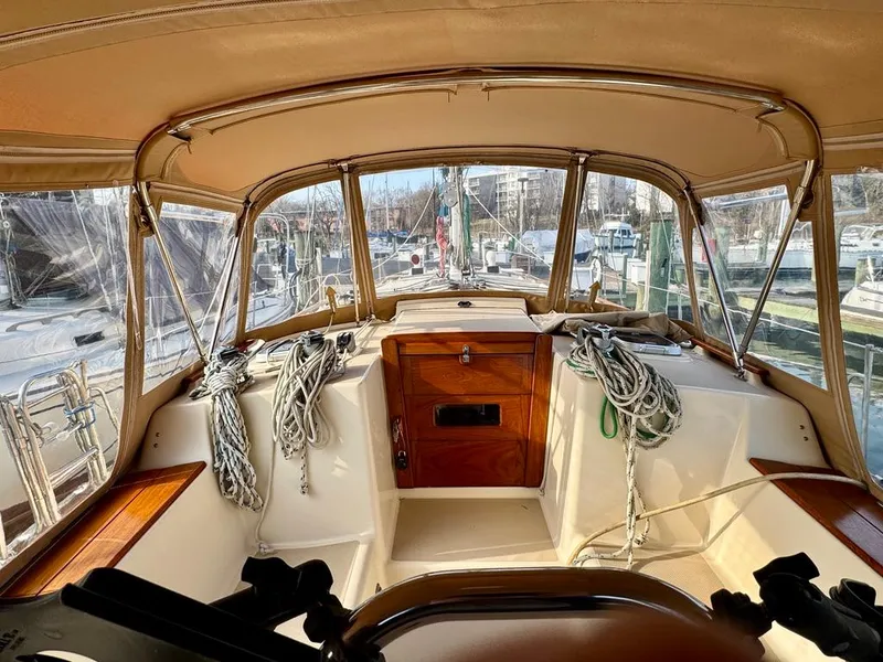 Slide: The Image of Interior view of 2000 Island Packet 40 sailboat cockpit with ropes and wooden accents. - 14