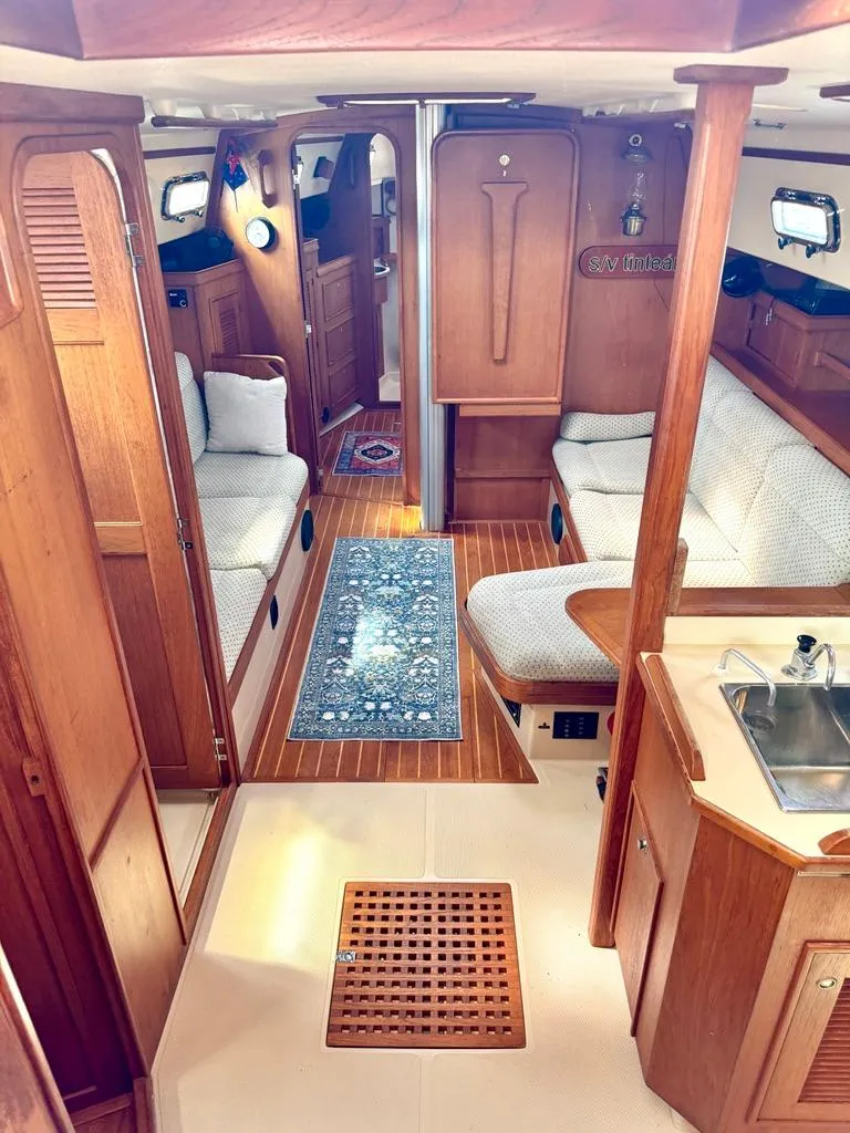 Slide: The Image of Interior of 2000 Island Packet 40 sailboat with wood finish and cozy seating area. - 15