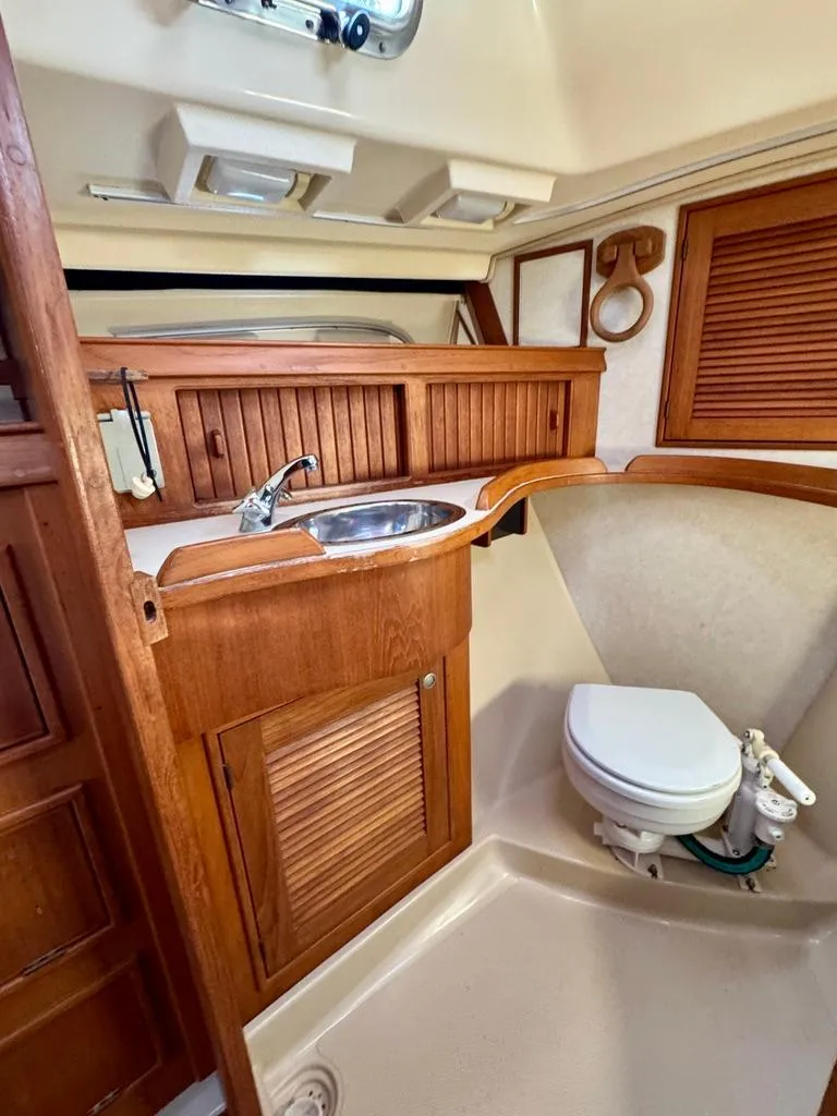 Slide: The Image of Island Packet 40 yacht bathroom, 2000 model, featuring wooden cabinetry and compact design. - 22