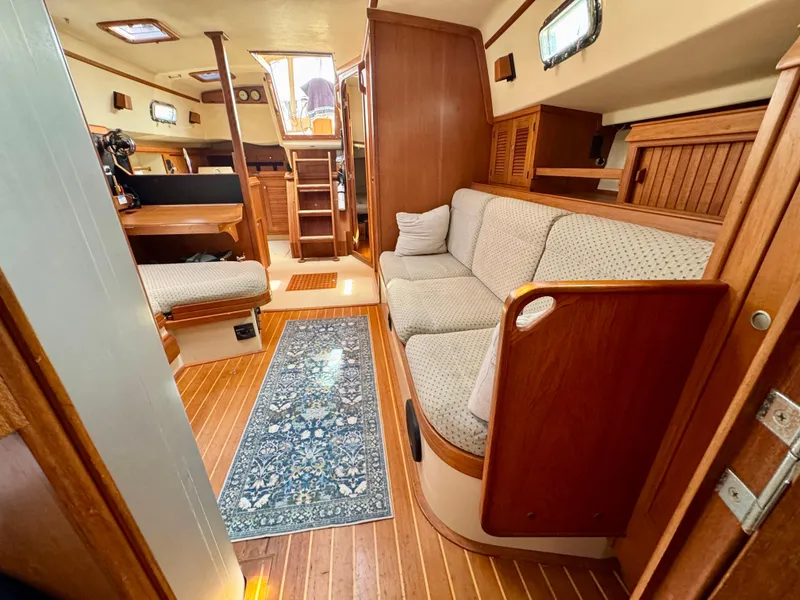Slide: The Image of Interior of 2000 Island Packet 40 sailboat with cozy seating and wooden finishes. - 26