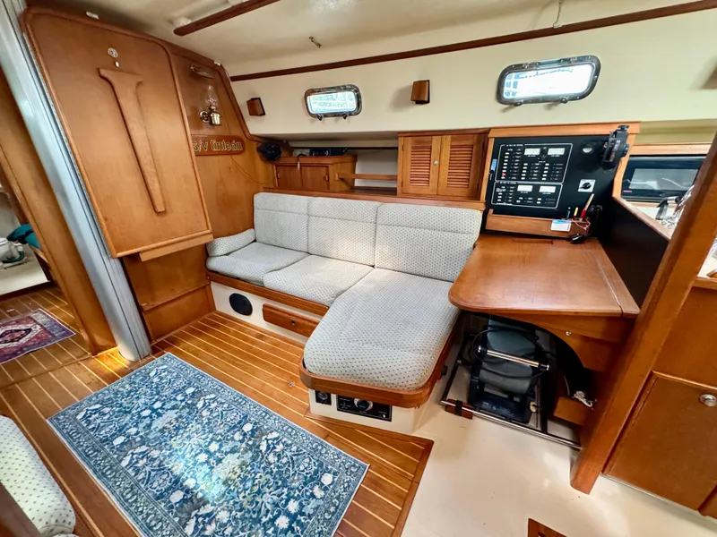 Slide: The Image of Interior of 2000 Island Packet 40 sailboat with cozy seating and navigation station. - 28