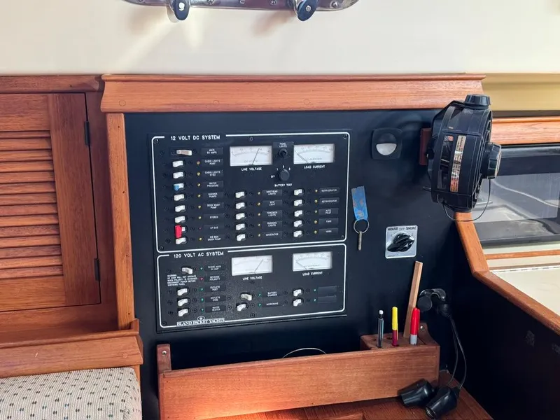 Slide: The Image of Electrical panel on a 2000 Island Packet 40 sailboat, featuring switches and controls. - 29