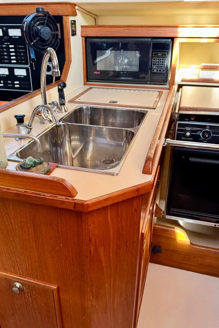 Slide: The Image of Island Packet 40 yacht kitchen with sink, microwave, and stove, 2000 model. - 33