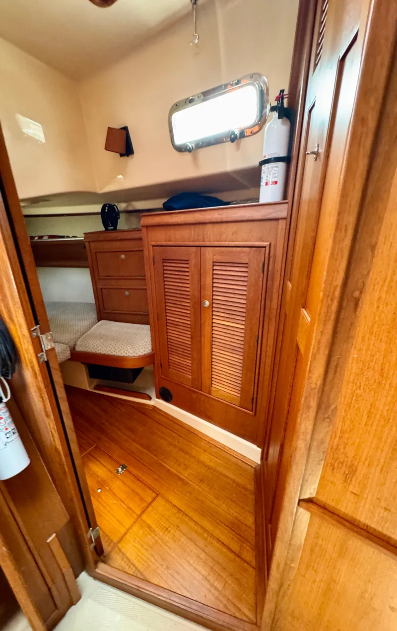 Slide: The Image of Interior cabin of 2000 Island Packet 40 sailboat with wooden furnishings and storage. - 36