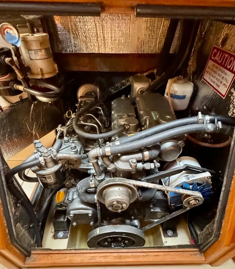 Slide: The Image of Engine compartment of a 2000 Island Packet 40 sailboat, showcasing mechanical components and wiring. - 38