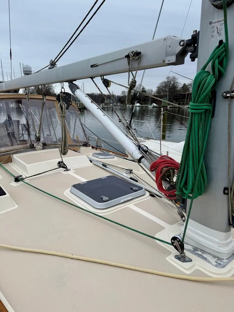 Slide: The Image of Island Packet 40 sailboat deck, 2000 model, with rigging and ropes, docked by the water. - 7