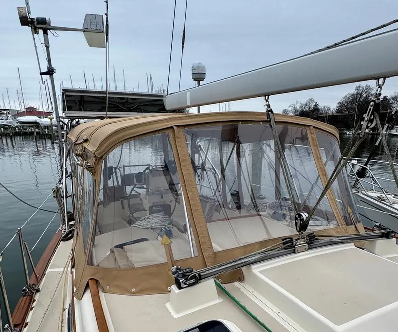 Slide: The Image of Island Packet 40 sailboat, 2000 model, docked with tan canopy and clear panels. - 9
