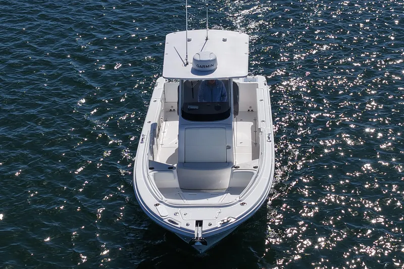 Slide: The Image of 2023 Edgewater 262CC boat cruising on sparkling water, aerial view. - 13