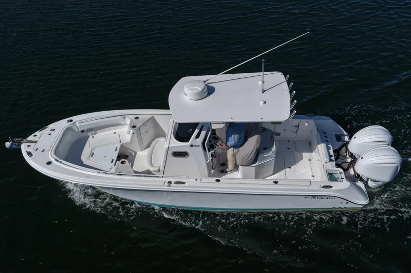 Slide: The Image of 2023 Edgewater 262CC boat cruising on open water, aerial view. - 14
